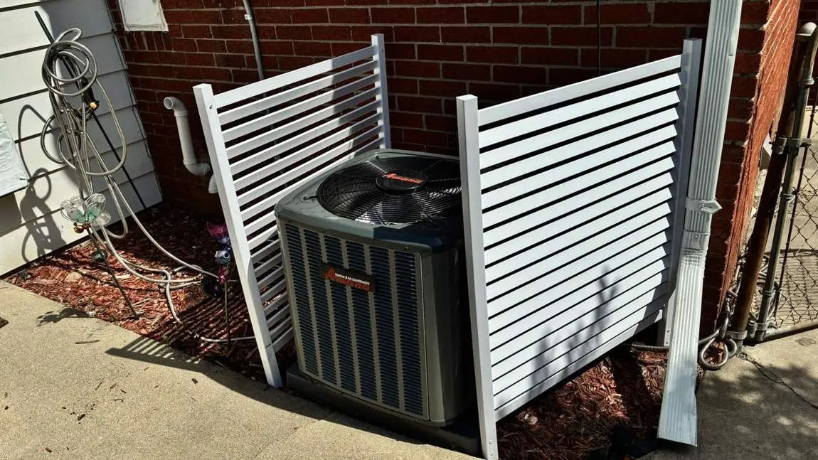 White privacy screen installed around an AC unit